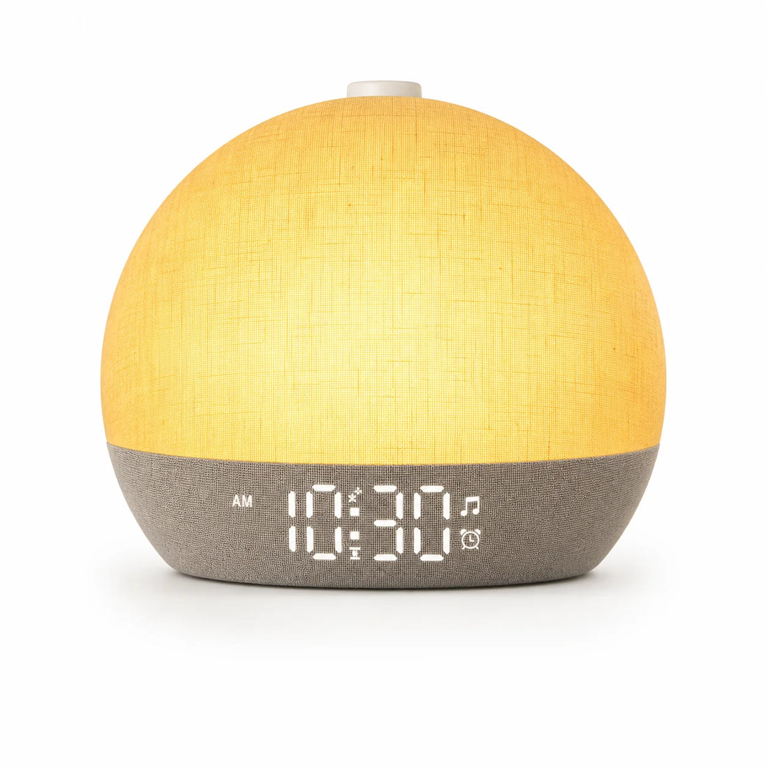 Réveil simulateur d'aube Matina posé sur une table de chevet, lumière orangée du matin